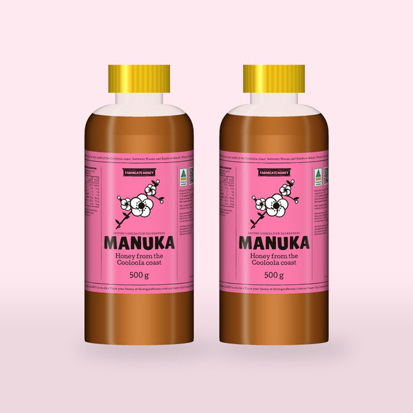 Two 500g bottles of Queensland Manuka Honey with the pink manuka label (a render of the new label, coming this season)