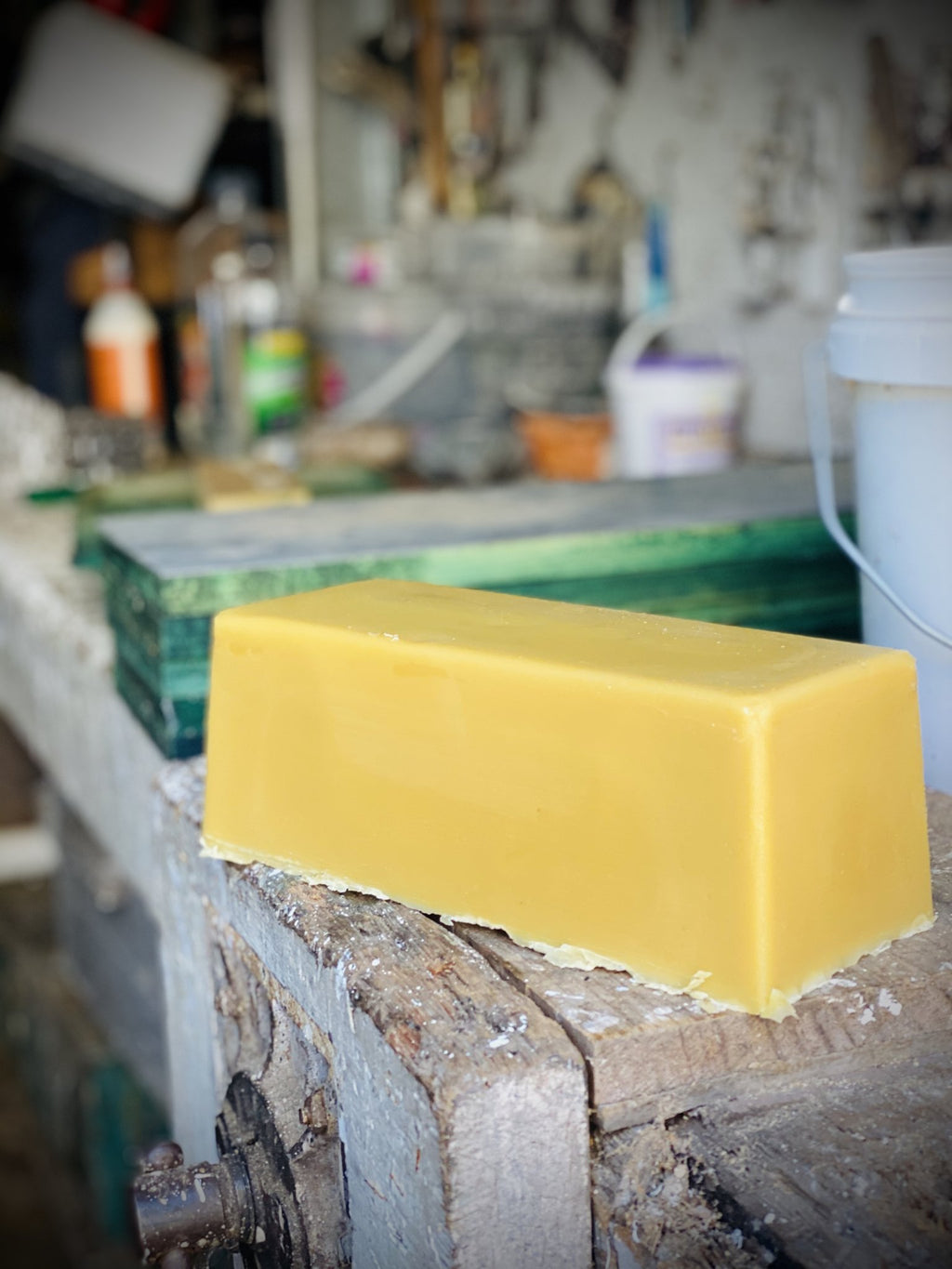 A block of beeswax on the bench in the shed