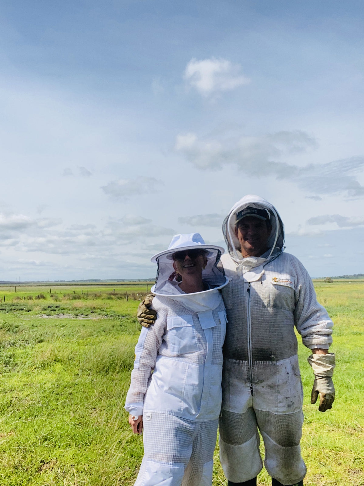 Megan and Murray in their beekeeping suits in a paddock at Peak Crossing