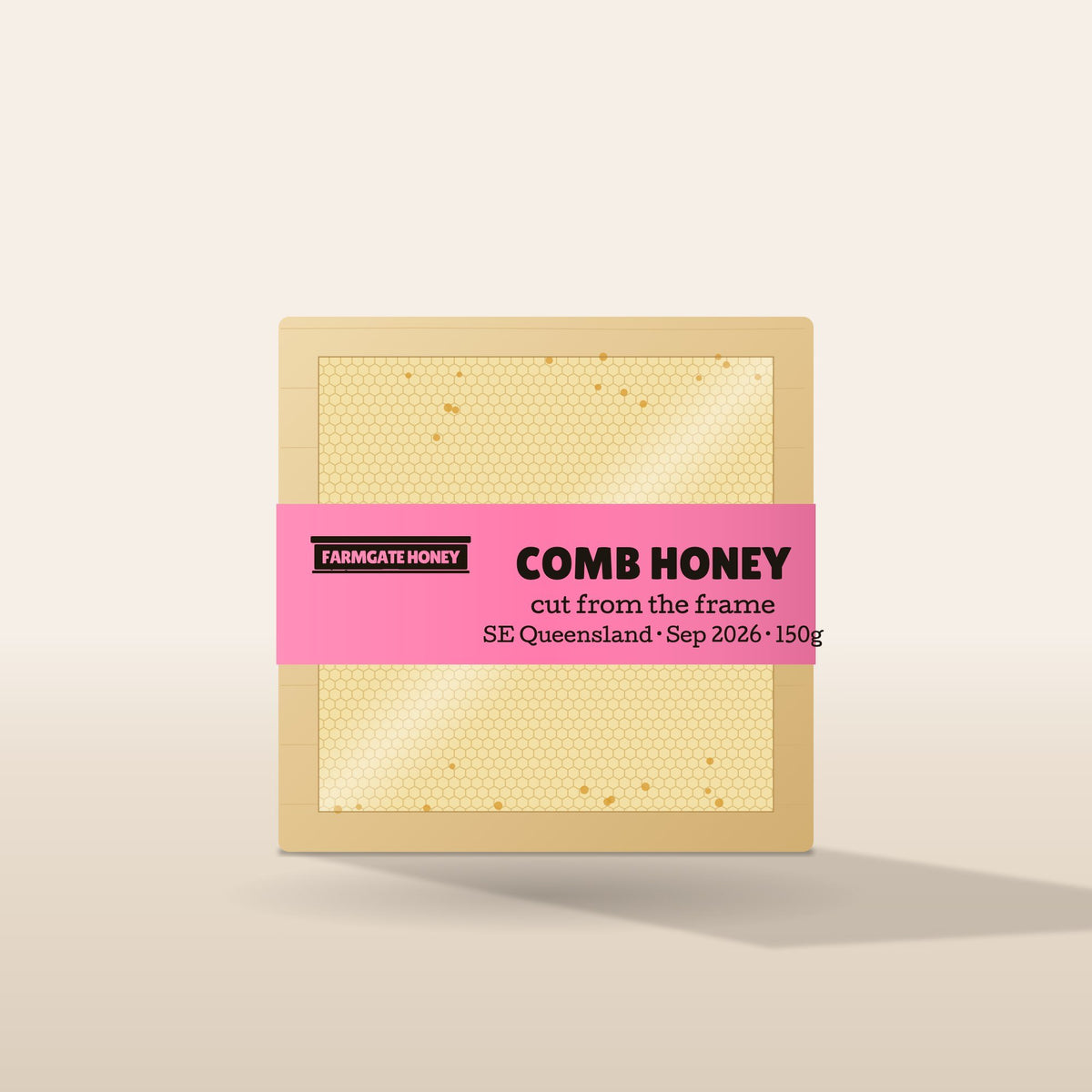 Comb honey in a timber section with the pink Farmgate Honey band (test label, coming this season)