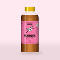 Queensland Manuka Honey in a clear squeeze bottle, the pink manuka label with a flowering tea tree drawn on the front (a render of the new label, coming this season)